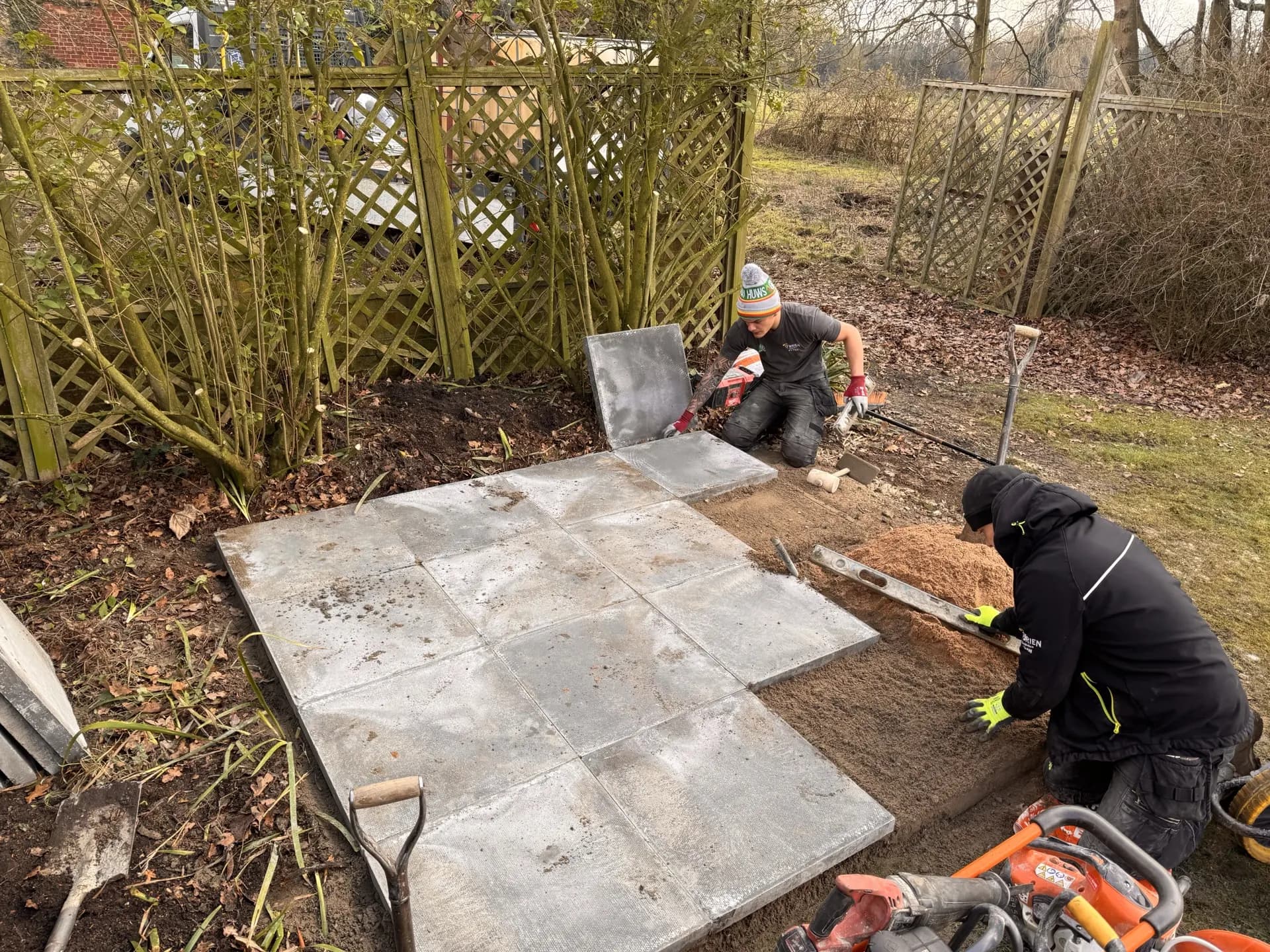 Engineers laying concrete slabs on a prepared oil tank sub-base
