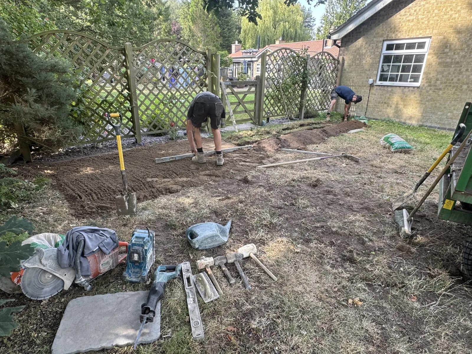 Engineers levelling the sub-base for a new domestic oil tank