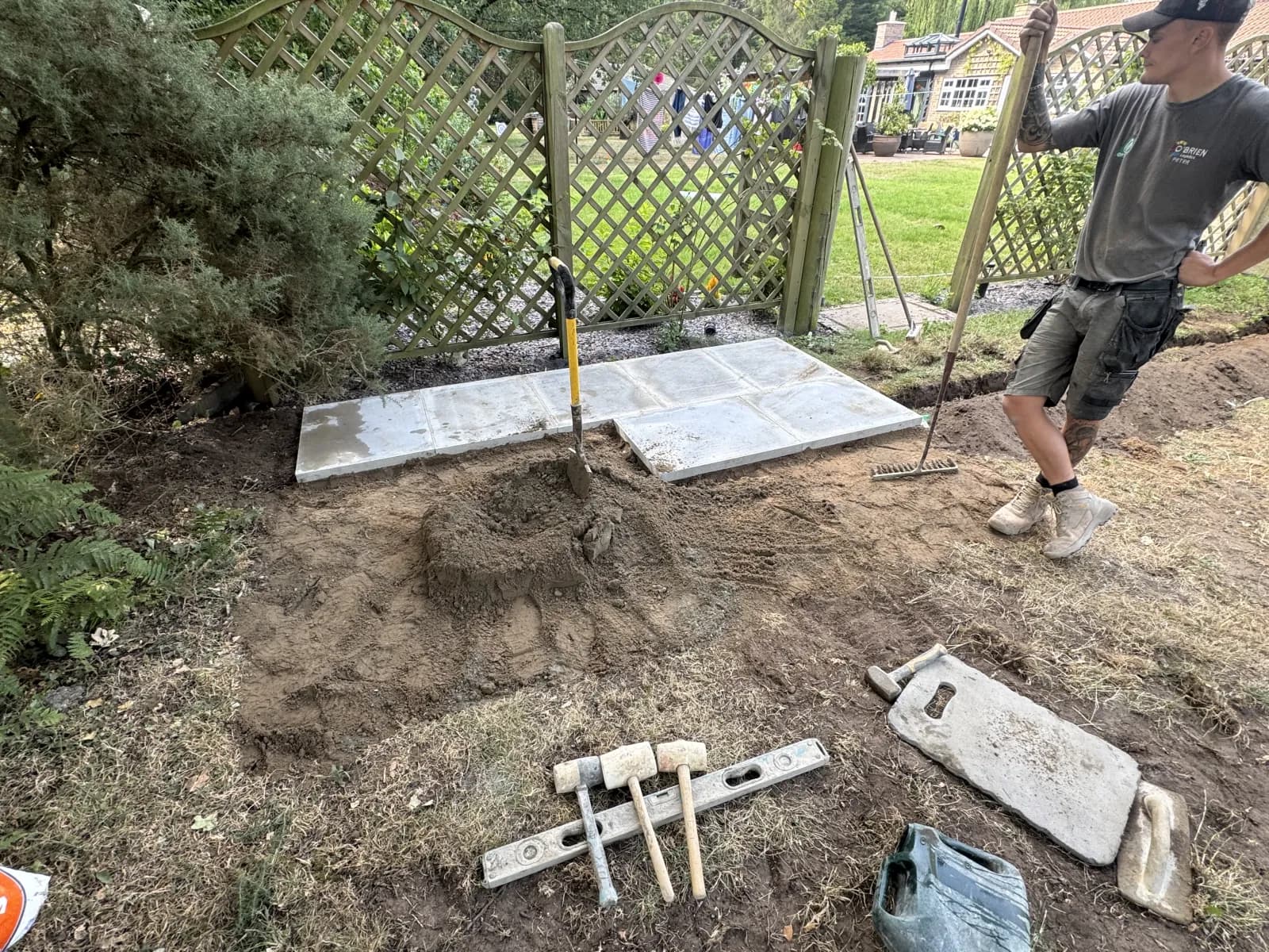 Engineer laying concrete paving slabs for a new oil tank base