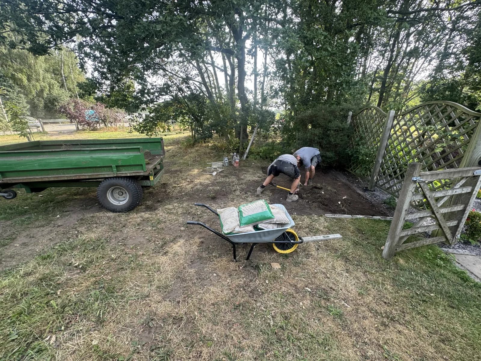 Oil tank engineers excavating a new tank position in a garden