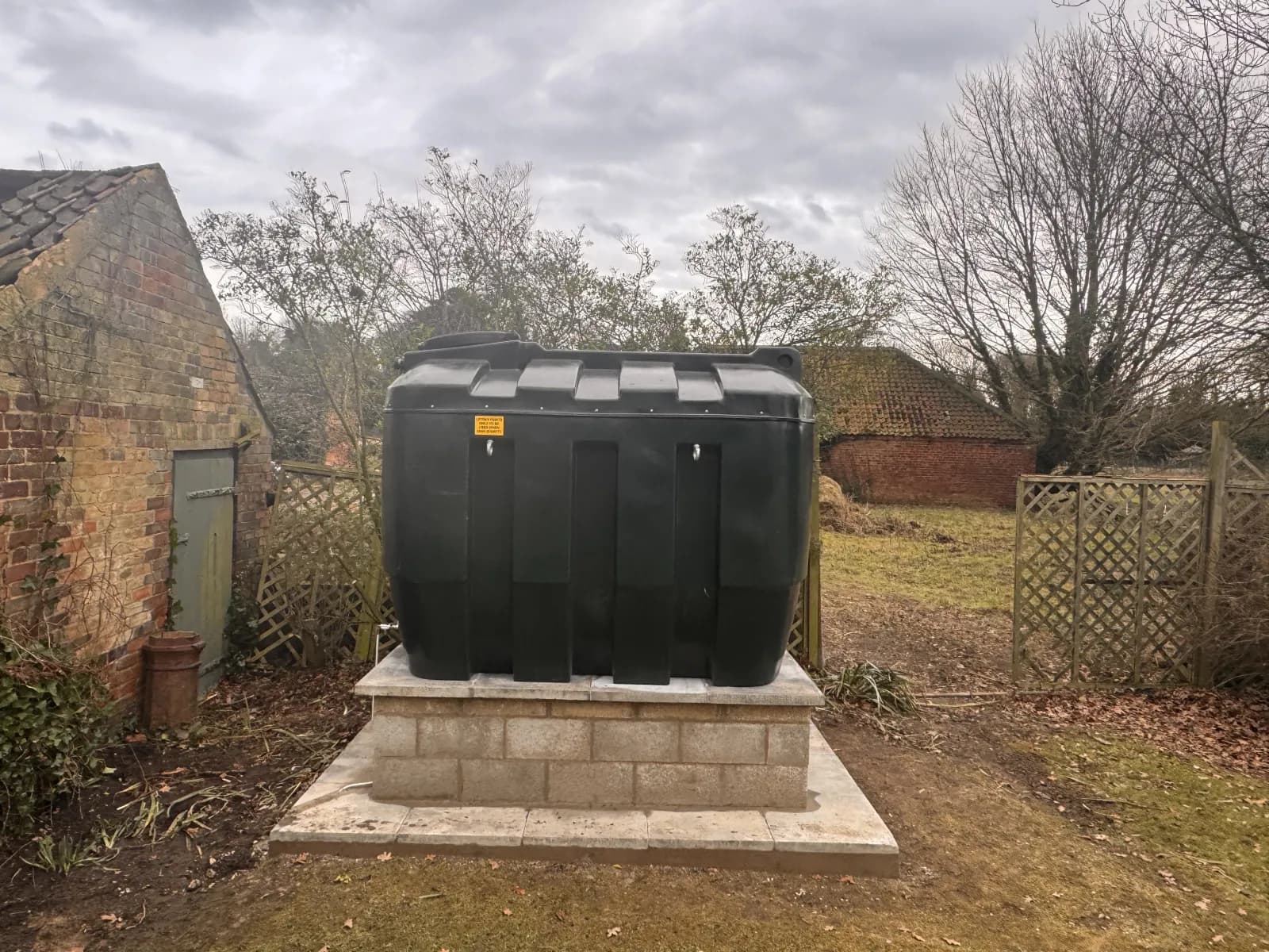 Black bunded oil tank installed on a completed raised blockwork base